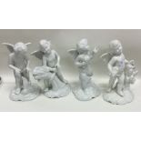 A set of four porcelain figures of children on rug