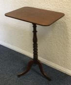 An early Victorian mahogany tilt-top table on thre