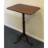 An early Victorian mahogany tilt-top table on thre