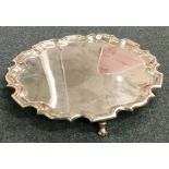 A circular silver salver of typical design. London