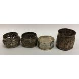 A group of four Continental silver napkin rings. A