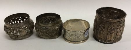 A group of four Continental silver napkin rings. A