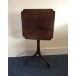 A mahogany occasional table with shaped top on thr