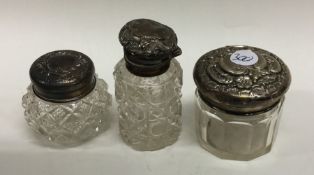 A group of three silver mounted scent bottles. Est