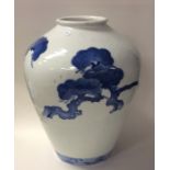 A tall blue and white tapering Eastern vase decora