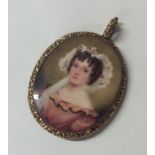 An attractive oval gold framed miniature of a girl