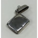 A silver vesta case of plain form with hinged top.