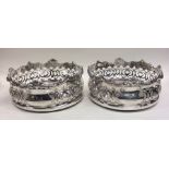 A good pair of silver plated pierced wine coasters