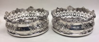 A good pair of silver plated pierced wine coasters