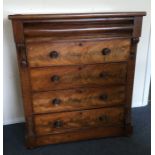 A flame mahogany chest of five drawers with turned