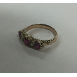 A good ruby and diamond five stone half hoop ring.