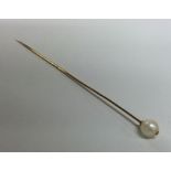 A 15 carat pearl mounted single stone stick pin. A