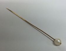 A 15 carat pearl mounted single stone stick pin. A
