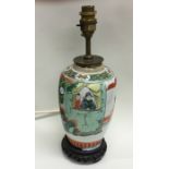 A Chinese vase on wooden base. Est. £25 - £35.