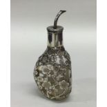 A Chinese silver and glass dimple sided bottle. Ma