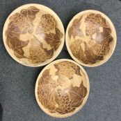 A set of three stoneware pottery bowls with incise