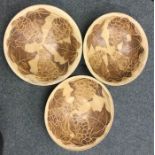 A set of three stoneware pottery bowls with incise