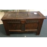 A Georgian oak panelled coffer with carved decorat