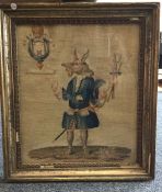 A gilt framed and glazed embroidery depicting a wo