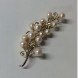 A gold and pearl brooch in the form of a sprouting