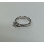 A large diamond single stone gypsy set ring in pla