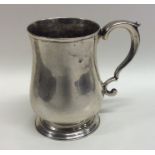 An early Georgian baluster shaped silver mug on ta
