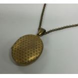 An Antique pinch back locket on chain. Approx. 24