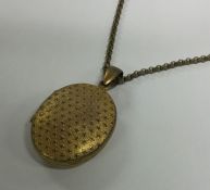 An Antique pinch back locket on chain. Approx. 24