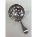 A George III bright cut silver caddy spoon. London