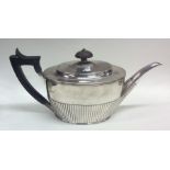A good Victorian silver teapot of half fluted desi