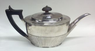 A good Victorian silver teapot of half fluted desi