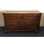 An Antique oak mule chest with hinged top and cros