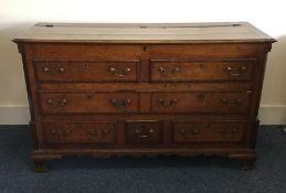 An Antique oak mule chest with hinged top and cros