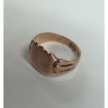 A 9 carat rose gold shield shaped signet ring with