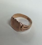 A 9 carat rose gold shield shaped signet ring with