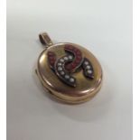 A heavy 15 carat gold locket with coral and pearl