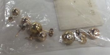 A bag containing various gold and other earrings.