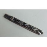 An Edwardian silver pencil decorated with flowers.