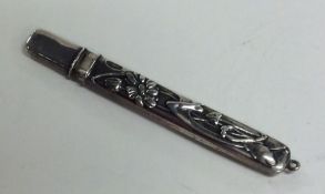 An Edwardian silver pencil decorated with flowers.