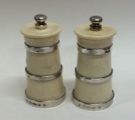 A pair of silver mounted pepper grinders of taperi