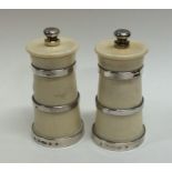 A pair of silver mounted pepper grinders of taperi