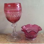 A large tapering cranberry glass goblet together w