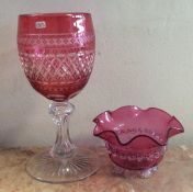 A large tapering cranberry glass goblet together w