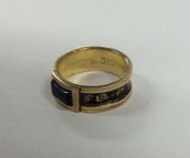 A Georgian 18 carat gold and enamelled mourning ri