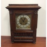 An oak cased mantle clock with silvered dial. Est.