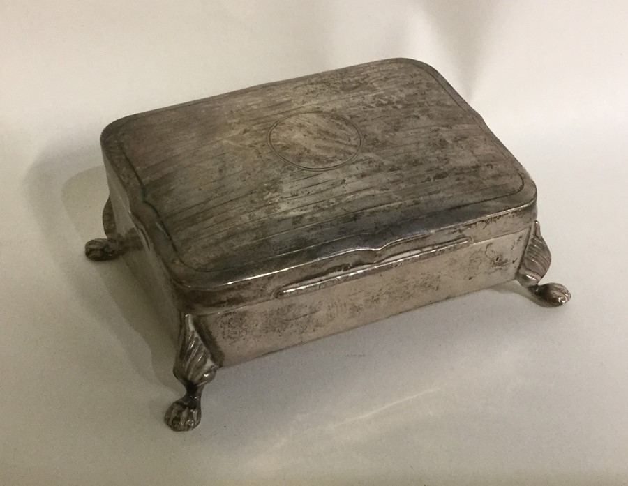 A silver hinged top jewellery box with fitted inte