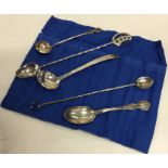 A stylish silver preserve spoon together with nume