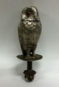 An unusual silver car mascot in the form of an owl