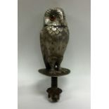 An unusual silver car mascot in the form of an owl