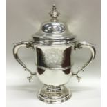 A large George II silver cup and cover on sweeping